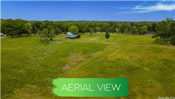Aerial view of Lot 6 in Saline County, Arkansas, in Hot Spring Village, showing a 0.22-acre residential land plot with surrounding nature.