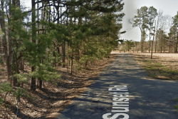 Aerial view of a 0.06-acre Pine Bluff lot in Jefferson County, Arkansas, with property boundaries marked in a detailed map image.