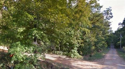 Aerial view of Ozark Acres in Ozark County, Arkansas, showing wooded 0.26-acre land parcel with clear boundaries.