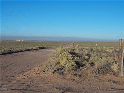 Aerial view of Arizona Navajo County 1.25-acre Rancho Lot 104 for sale, featuring desert landscape and open skies.