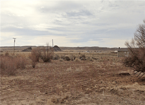 Aerial view of Lot 16 in Navajo County, Arizona ranch with open land and surrounding natural scenery, part of a 5-acre property.