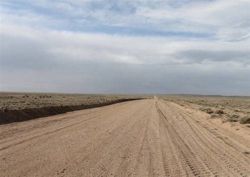 Aerial view of Colorado San Luis Ranches Lot 3 in Costilla County, showing open 5-acre land with natural landscape and surrounding terrain.