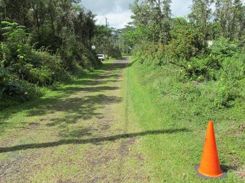 Aerial view of Hawaii Nanawale Estates lot near Hilo with visible land, road, and surrounding natural landscape.