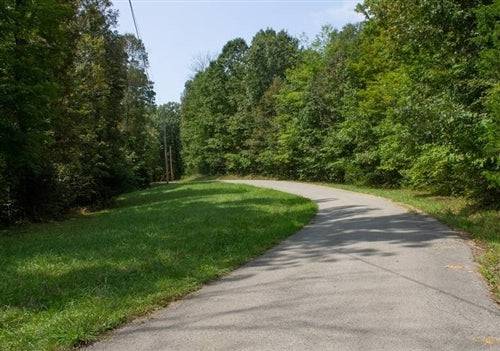 Aerial view of 9.14-acre Bluegrass Ridge Lot 11 in Wayne County, Kentucky, showing open land and surrounding greenery.