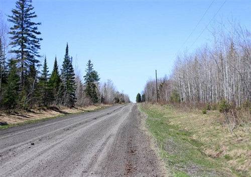 Aerial view of Michigan's Baraga County 20-acre Abby Point land parcel with trees and lake frontage.
