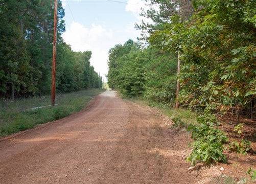 Aerial view of Wagon Wheel Ranch Lot 53, a 7.50-acre property in Dent County, Missouri, with open land and surrounding trees.