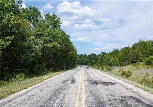 Aerial view of Missouri Taney County Wild Wood Lot 4, showing wooded 10-acre property with natural landscape and trees.