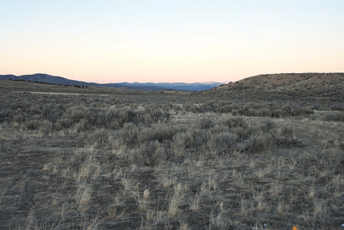 Aerial view of Nevada Elko County Gamble District 40-acre land parcel, section SE4 NW4 in T40N R67E, with surrounding landscape.