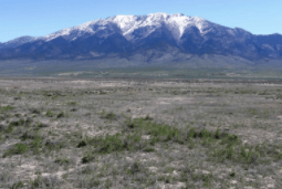 Aerial view of Nevada Elko County Mountain Meadow Ranches Lot 839, featuring open land and surrounding mountain scenery.