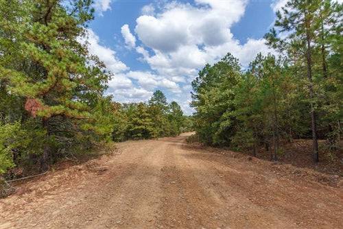 Aerial view of Oklahoma Latimer County 41.24-acre land lot with stone bridge, showcasing natural landscape and property features.