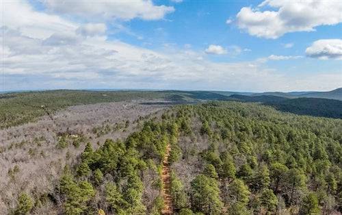 Aerial view of a 9.38-acre stone bridge lot in Latimer County, Oklahoma, showing open land and natural surroundings.