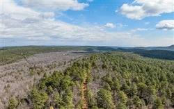 Aerial view of Oklahoma Latimer County Stone Bridge III 26.06-acre lot, showing natural landscape and property boundaries.