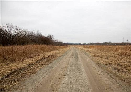Aerial view of Oklahoma Pittsburg County 7.01-acre Canadian Plains lot 29, open grassy field with trees along the border.