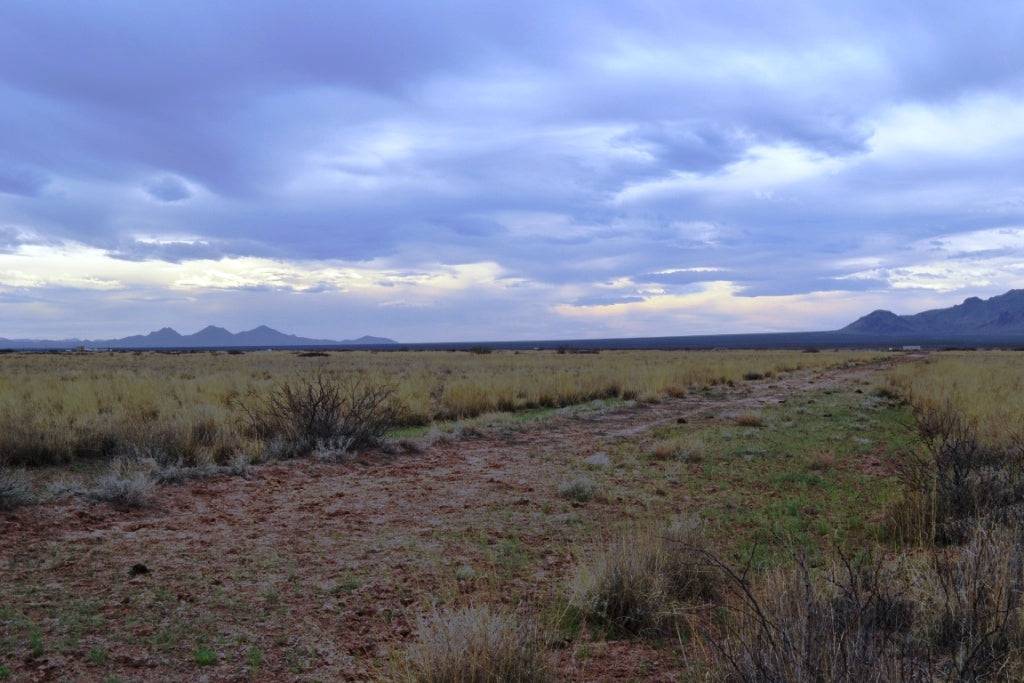 Aerial view of two adjoining 1-acre lots in Sunshine Valley Ranchettes, Luna County, New Mexico, with open land and clear skies.