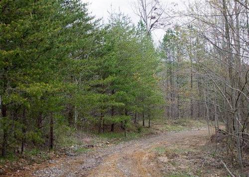 Aerial view of Tennessee Sequatchie County 5.8-acre Hidden Hills Lot 48 in a rural landscape with trees and open land.