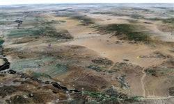 Aerial view of 1.24-acre Lake Havasu land in Mohave County, Arizona, with surrounding desert landscape and water nearby.