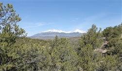 Aerial view of 5.18-acre land parcel in Sangre De Cristo Estates, Alamosa County, Colorado, with surrounding natural landscape.