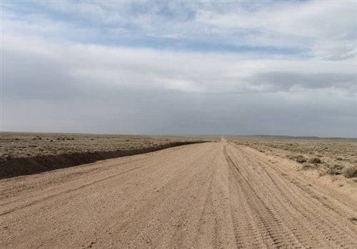 Aerial view of a 5-acre property in Costilla County, San Luis Valley, Colorado, with open land and mountainous background.