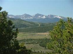 Aerial view of Eagle Ridge Ranch in Costilla County, Colorado, highlighting scenic 48.56-acre land with rolling terrain.