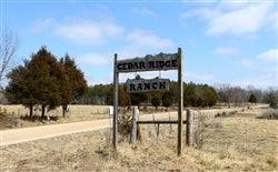 Aerial view of Missouri Phelps County Cedar Ridge Ranch 5.23-acre property, featuring wooded land and open spaces.