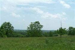 Aerial view of 6.65-acre Whispering Oaks Ranch in Texas County, Missouri, showing wooded land and open areas.