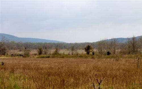 Aerial view of a 5.01-acre Daisy Meadows property in Pittsburg County, Oklahoma, with surrounding natural landscape and open land.