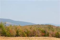 Aerial view of Oklahoma Pittsburg County 9.89-acre property with pond at Daisy Meadows, offered by Onlinelandsales.