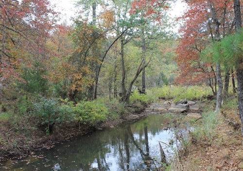 Aerial view of Oklahoma Pittsburg County Indian Ridge III 13.37-acre creekfront land with electricity, offered by Onlinelandsales.