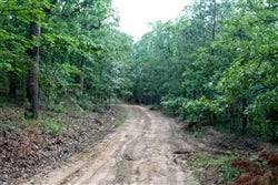 Aerial view of Oklahoma Trophy Ridge property in Pushmataha County, showing lush landscape and wooded acreage for sale.