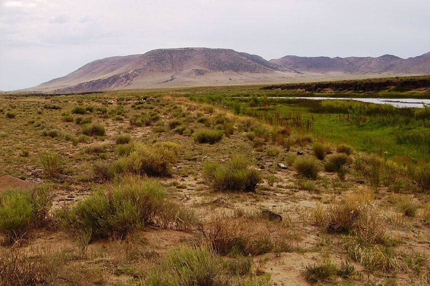 Aerial view of Colorado Costilla County 0.25-acre Rio Grande River lot near the river, showcasing natural landscape and surrounding terrain.