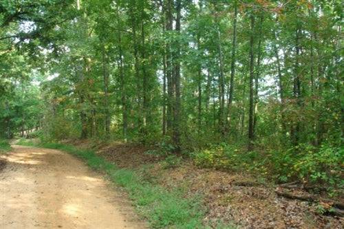 14.72-acre Sugartree Falls land in Wayne County, Tennessee, offered by Onlinelandsales, showing lush wooded property with natural landscape.