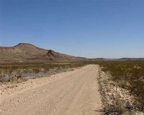Aerial view of 10-acre Texas property in Brewster County, Terlingua Ranch, featuring rugged desert landscape and open land.