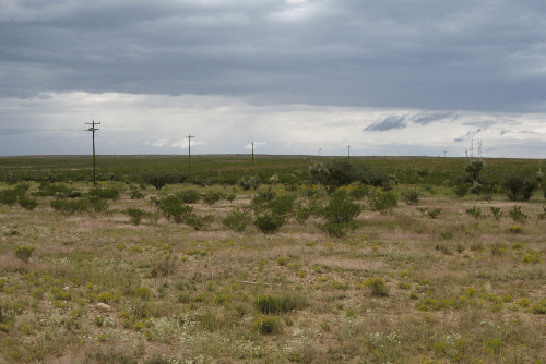 Aerial view of Texas Hudspeth County 4.87-acre La Hacienda Estates Lot 698, showcasing open land and surrounding natural terrain.