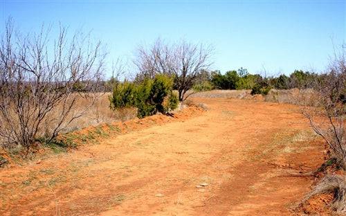 Aerial view of Texas Knox County Red Rock Ranch Lot 12, 22.52 acres with open land and scenic natural features.