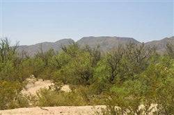 Aerial view of Texas Hudspeth County Sunset Ranches Lot 16 Unit 409, showing open land and scenic sunset skies.